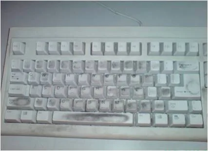Close-up of contamination and debris under office keyboard keys