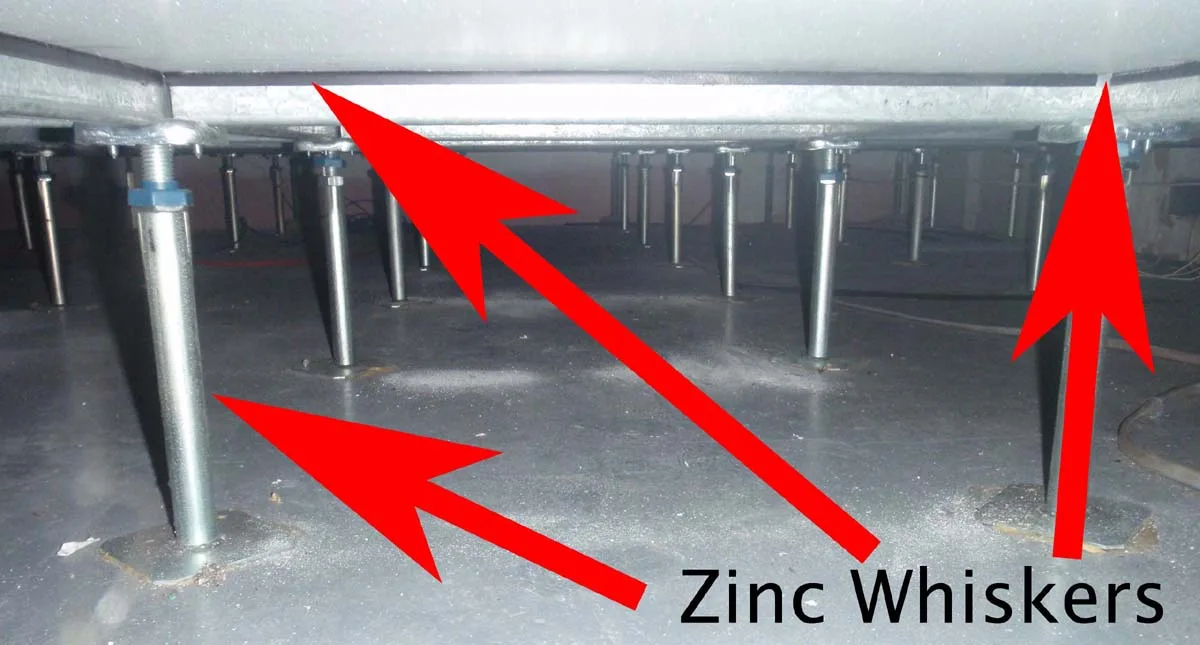 Subfloor tile underside covered in zinc whisker growth